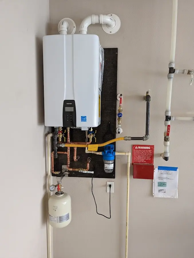 Professional plumber installing copper piping in a Bel Air North home